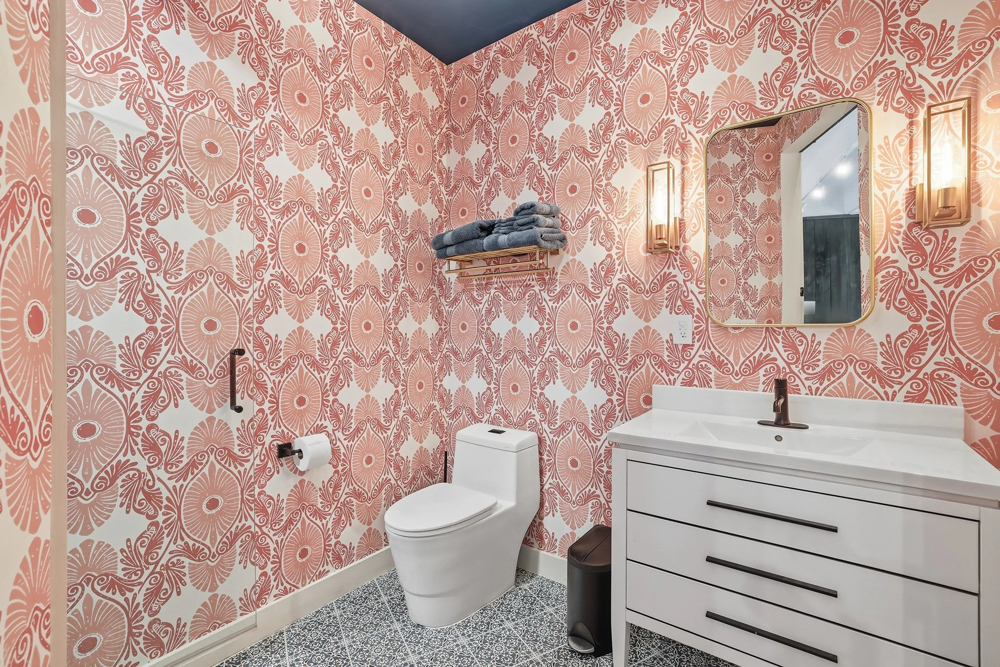 Discover the guest bath with A-Street wallpaper and midnight blue ceiling