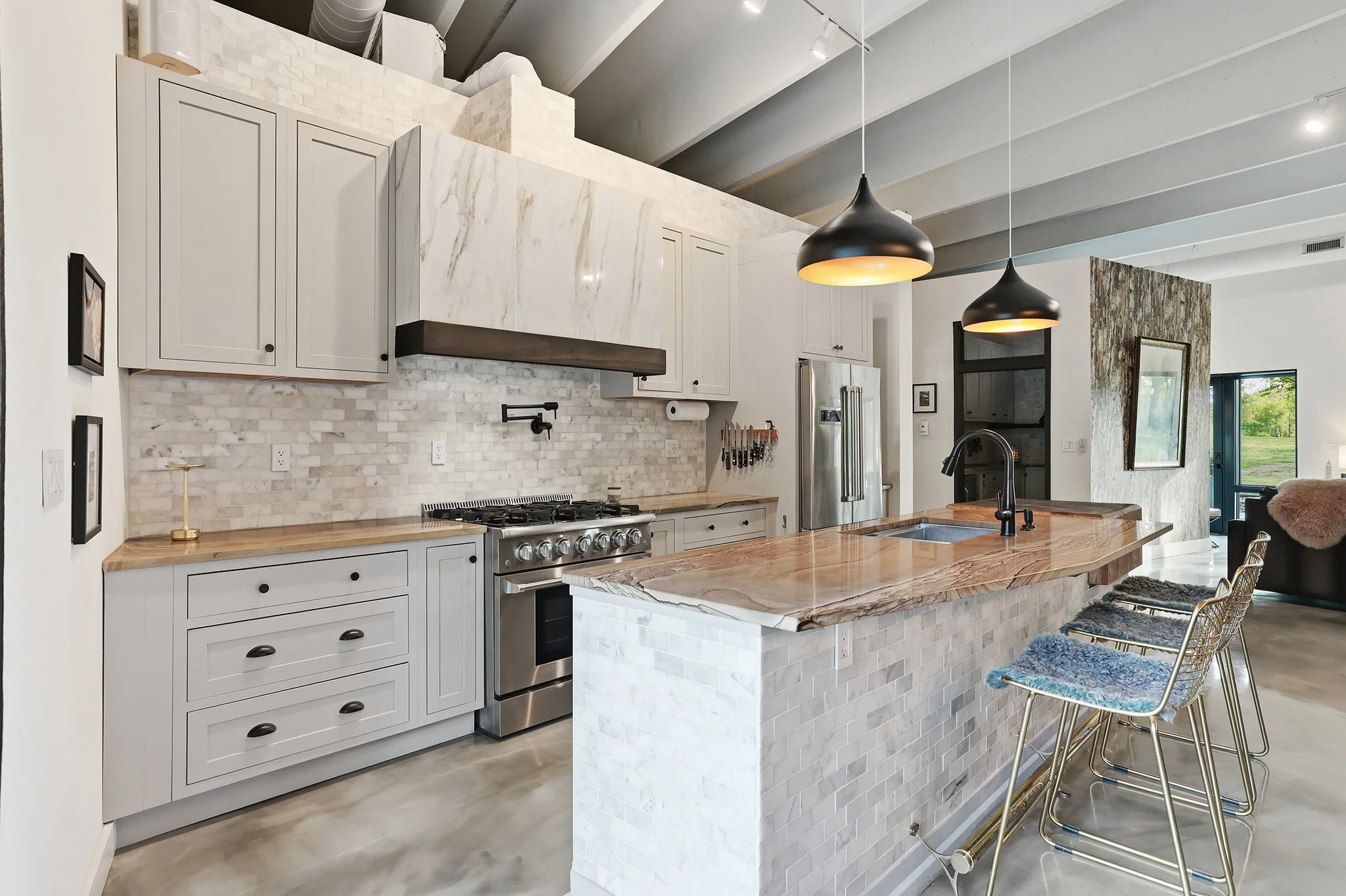 Chef’s kitchen with custom commercial vent hood keeps the air clean