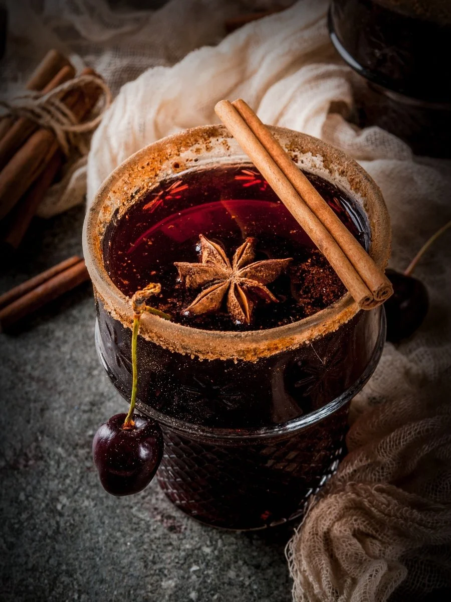 Cup of coffee with cinnamon and citrus fruits. The depiction is of a sangria inspired coffee.
