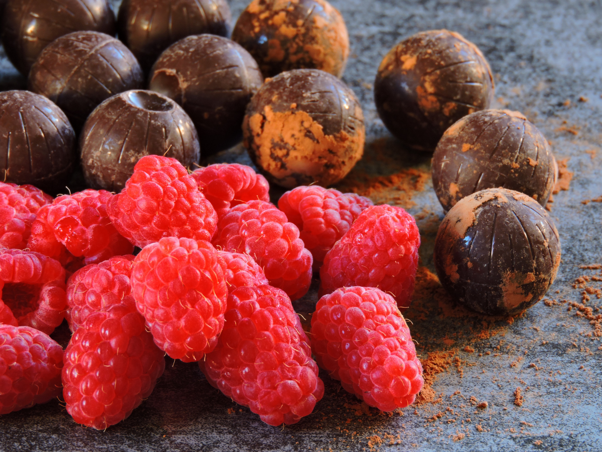 Photo of fresh raspberries and chocolate truffles.
