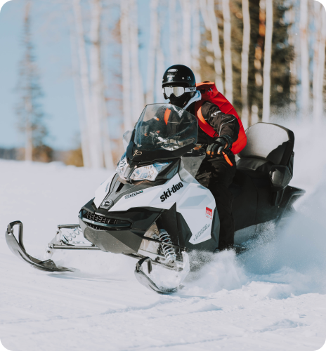 a man riding on a snowmobile