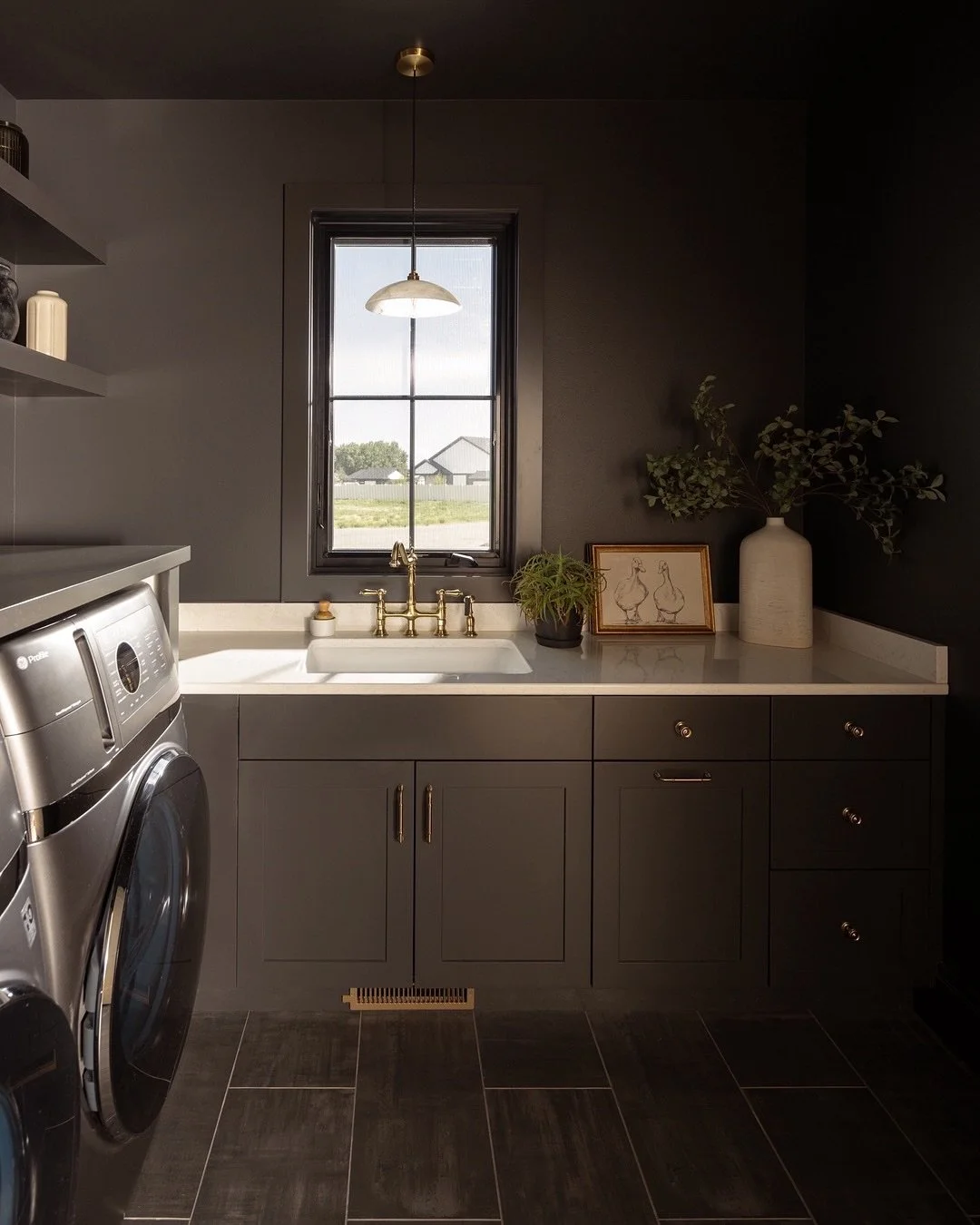 Who says a laundry room can&rsquo;t make a statement? 
⠀⠀⠀⠀⠀⠀⠀⠀⠀
This moody, layered space proves that even the most task-oriented rooms deserve thoughtful design. We spend so much of life in these in-between spaces &mdash; folding clothes, sorting, 