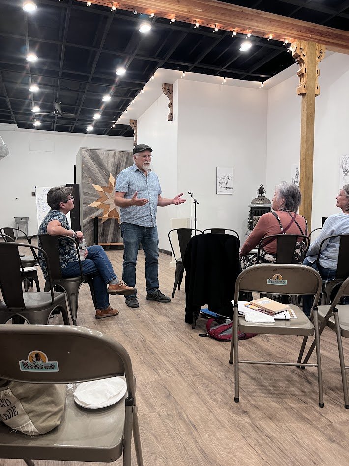 Older white male poet presenting a dramatic piece. 