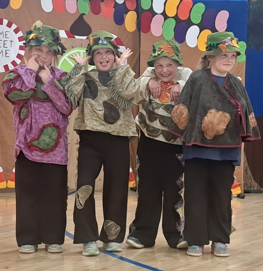 Group of youth actors still in their costumes from a production of Jack and the Beanstalk. 