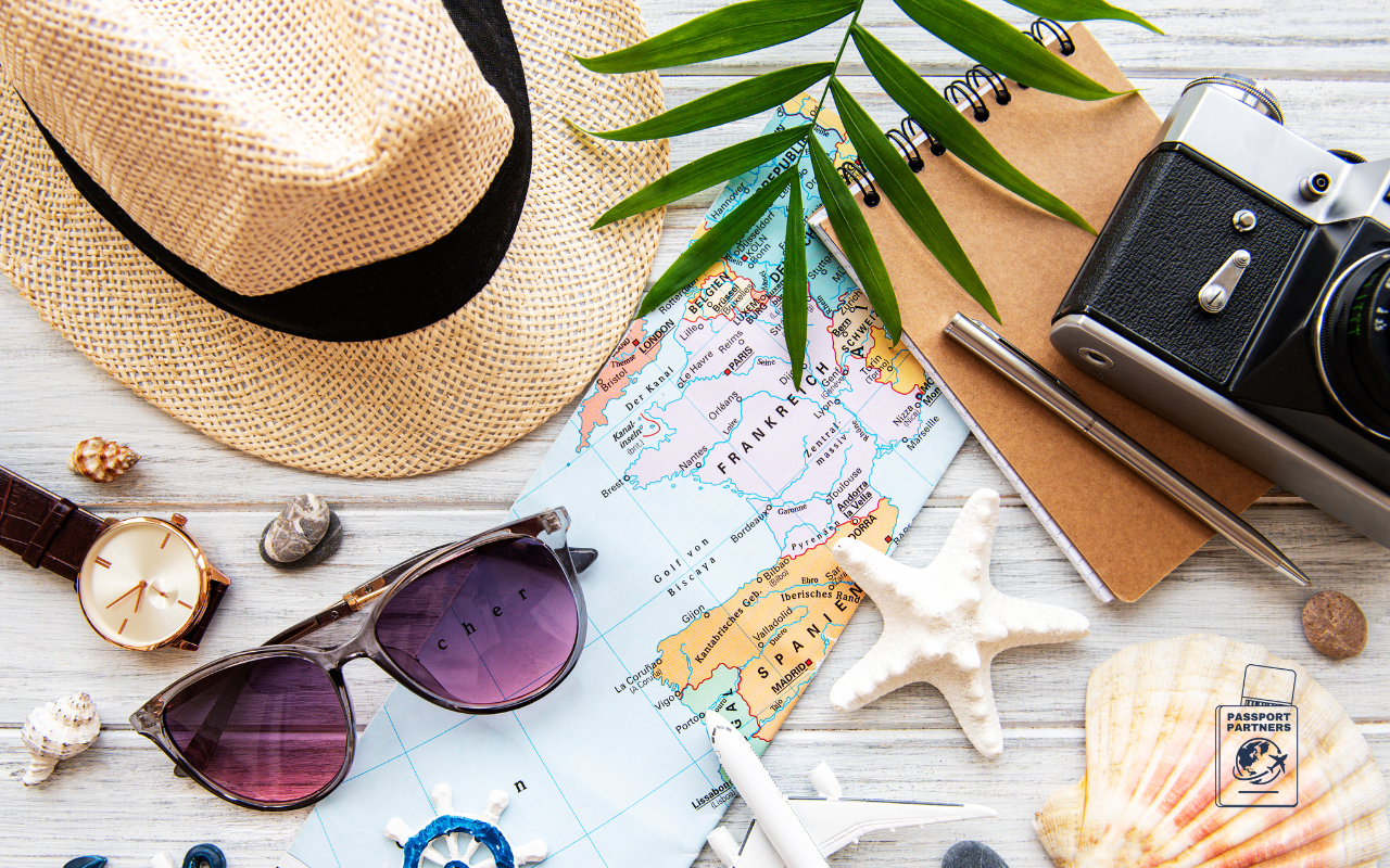 map, hat, sun glasses, starfish, pen, paper, camera