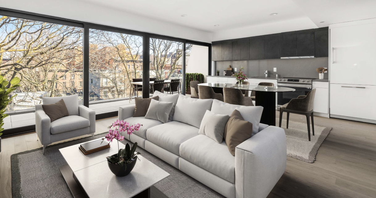 Modern living room with large floor-to-ceiling windows, white sofa and armchair, coffee table with pink orchid, open kitchen with black cabinets, dining table with chairs, and cityscape view outside.