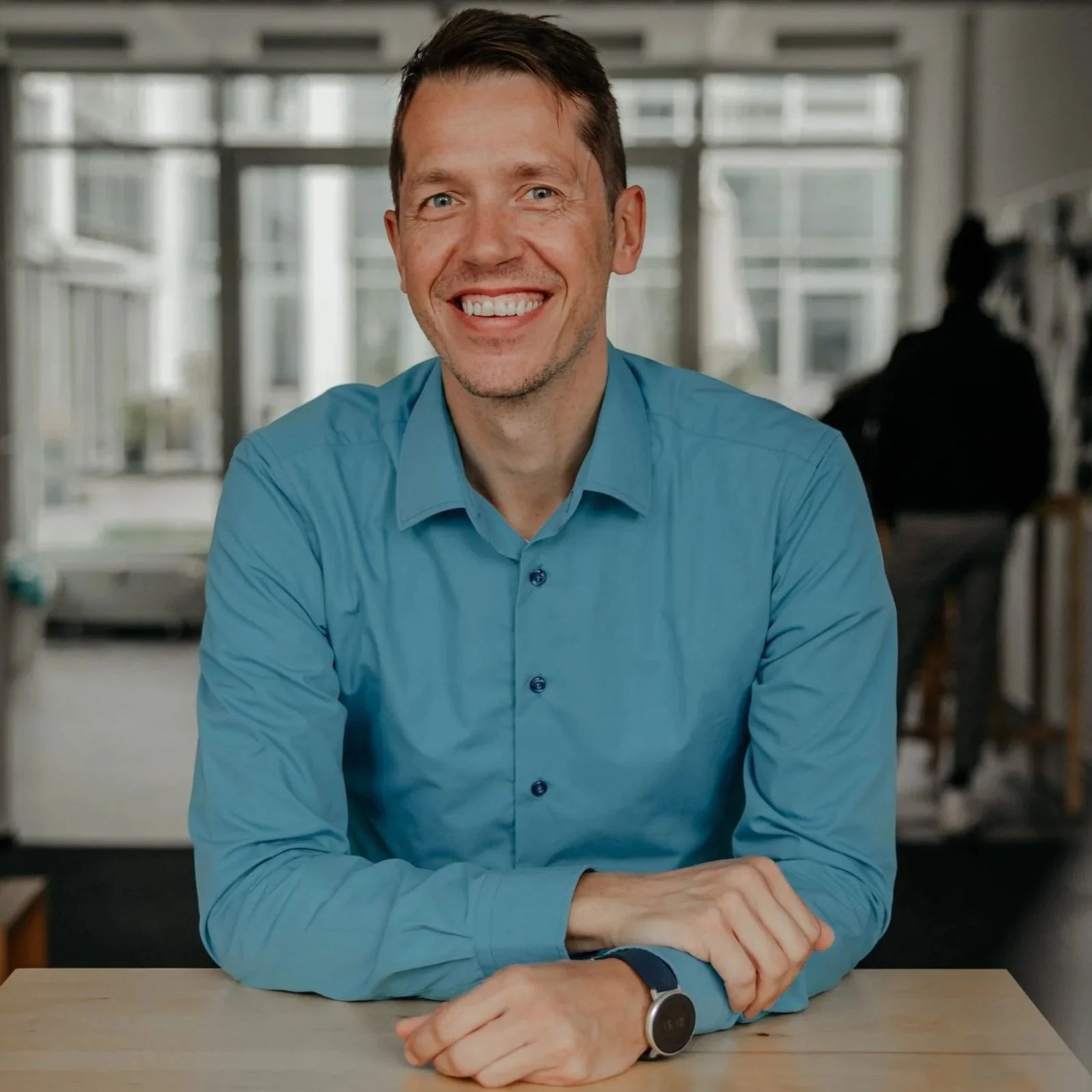 Portrait of a man , smiling, looking directly at the camera.