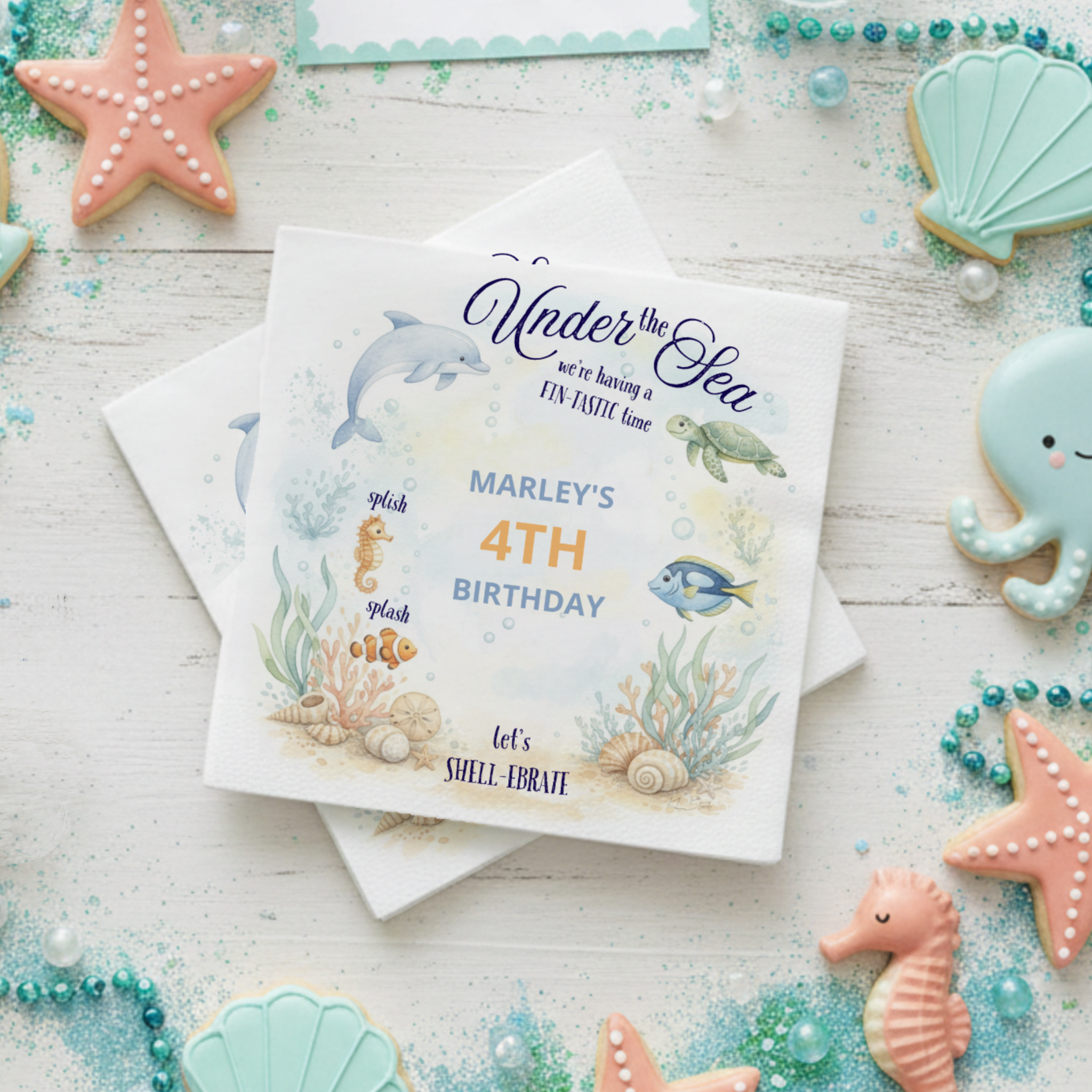 Under the Sea birthday party napkins featuring a playful watercolor ocean scene with seahorse, sea turtle, dolphin, and tropical fish in teal, turquoise, coral, and sea foam hues. Fun “FINtastic Time,” “Splish Splash,” and “Let’s SHELL-ebrate!” capti