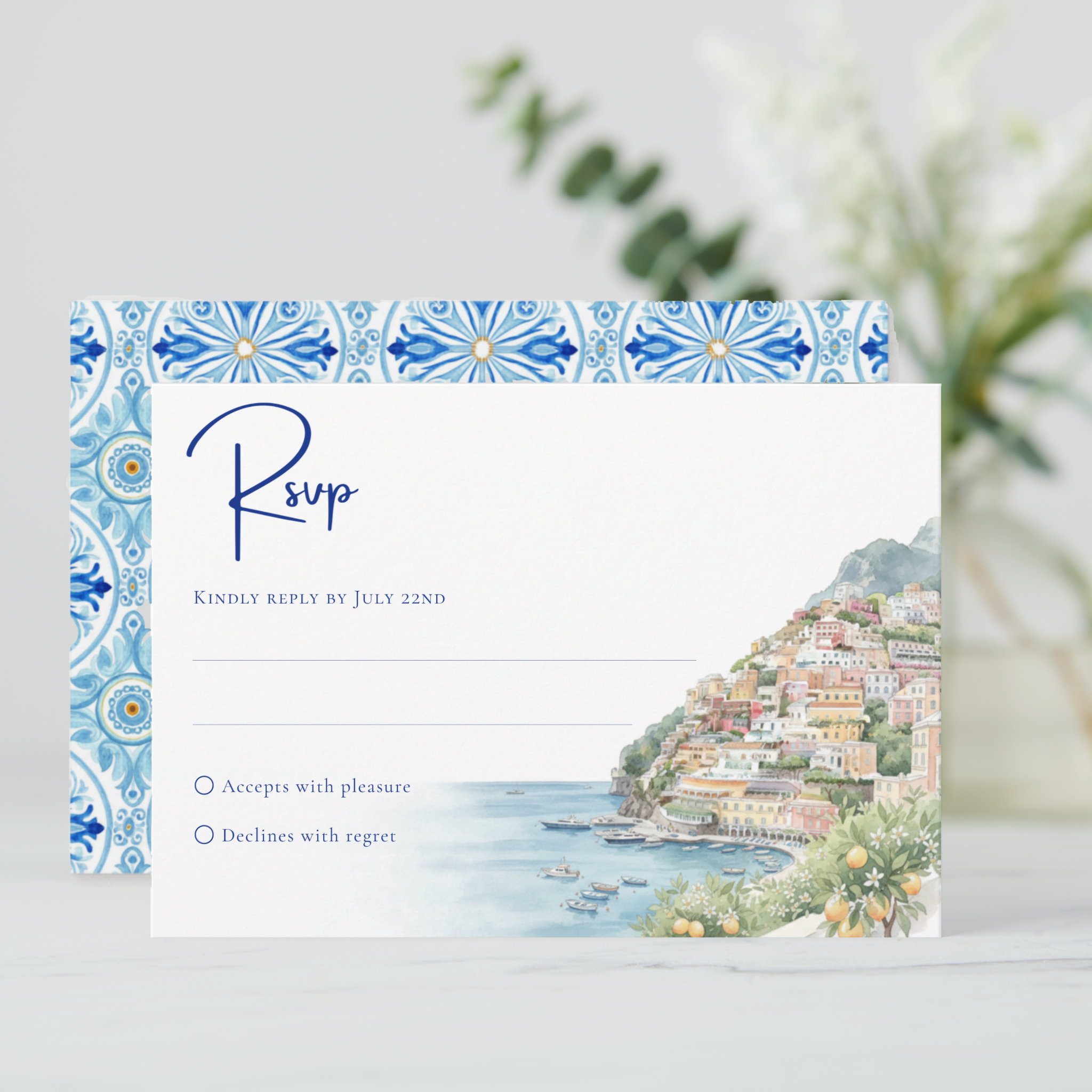 RSVP card featuring a watercolor Amalfi Coast seaside village and harbor scene, with a coordinating Mediterranean tile pattern on the reverse.

