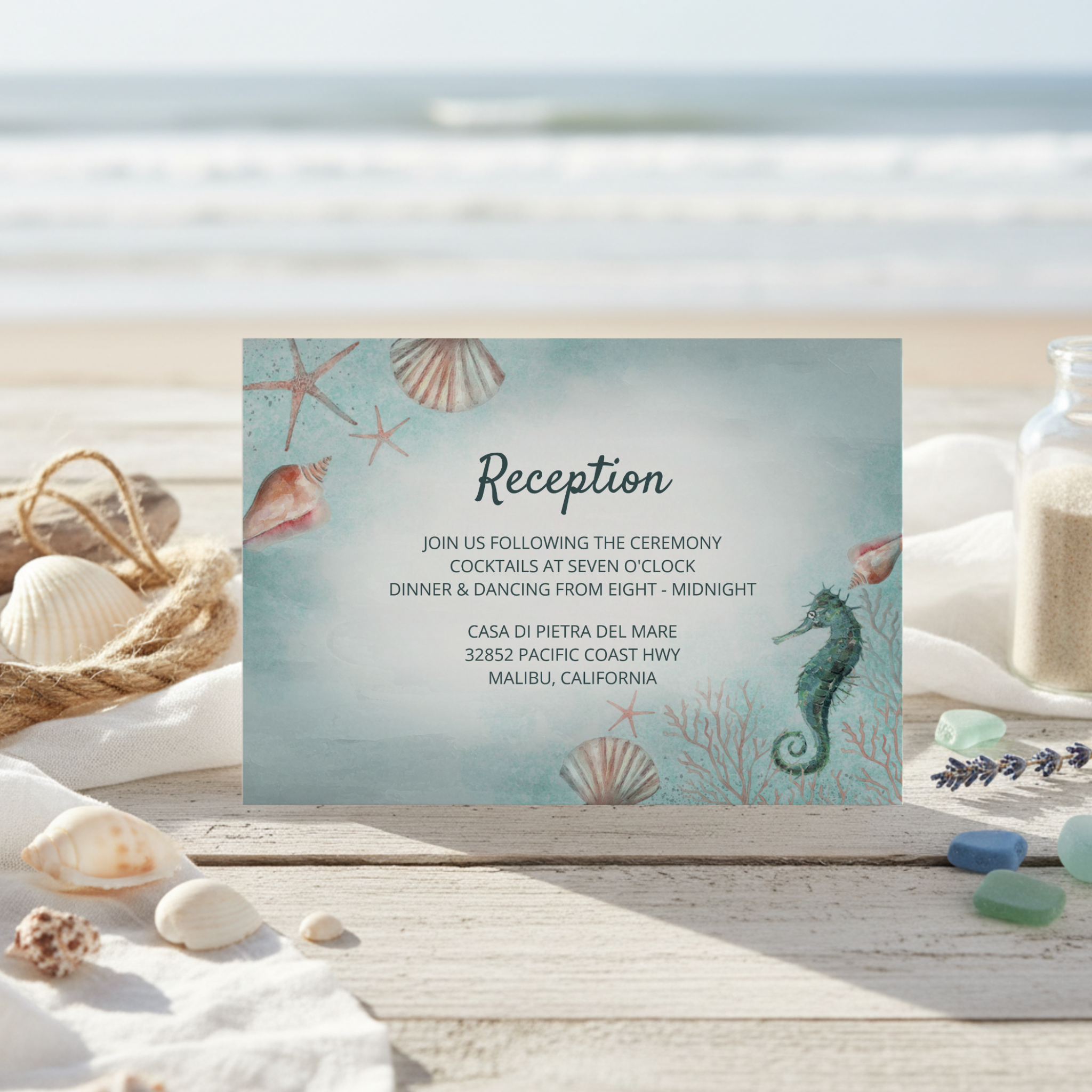 Beach theme wedding reception card features a weathered ocean blue watercolor brushstroke background with a seahorse, seashells, and coral. Perfect for tropical, summer, destination, nautical, coastal, and "Under the Sea" themes. 