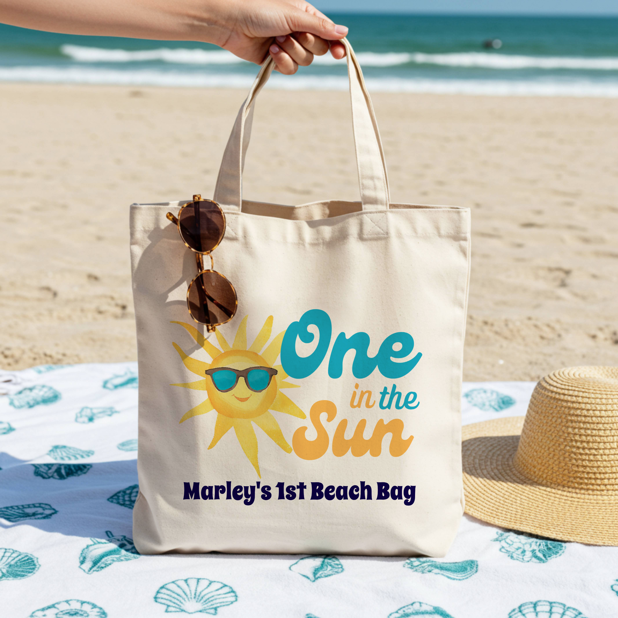 One in the Sun beach tote bag for baby's first birthday party featuring a cheerful sunshine and retro typography in turquoise and coral - customizable and perfect for summer baby birthdays with coastal themes