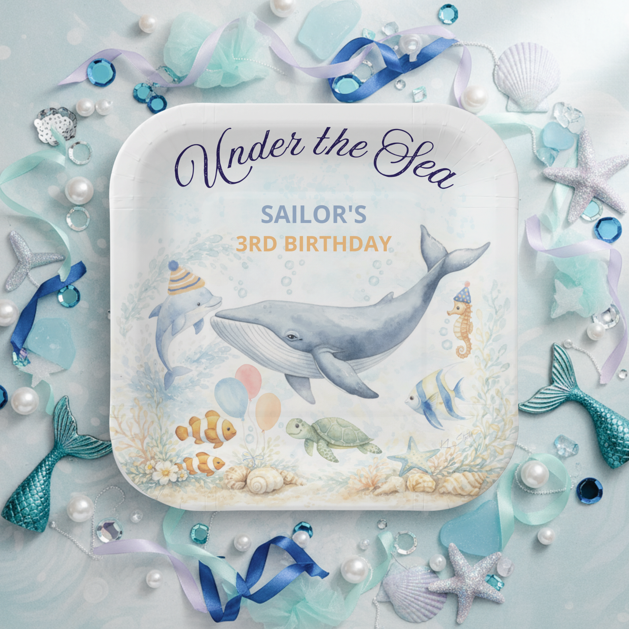 Under the Sea Whale birthday paper plates featuring a graceful watercolor humpback whale with a playful dolphin, seahorse, sea turtle, and tropical fish gathered around a soft coral reef. Finished with nautical “Under the Sea” script and personalized