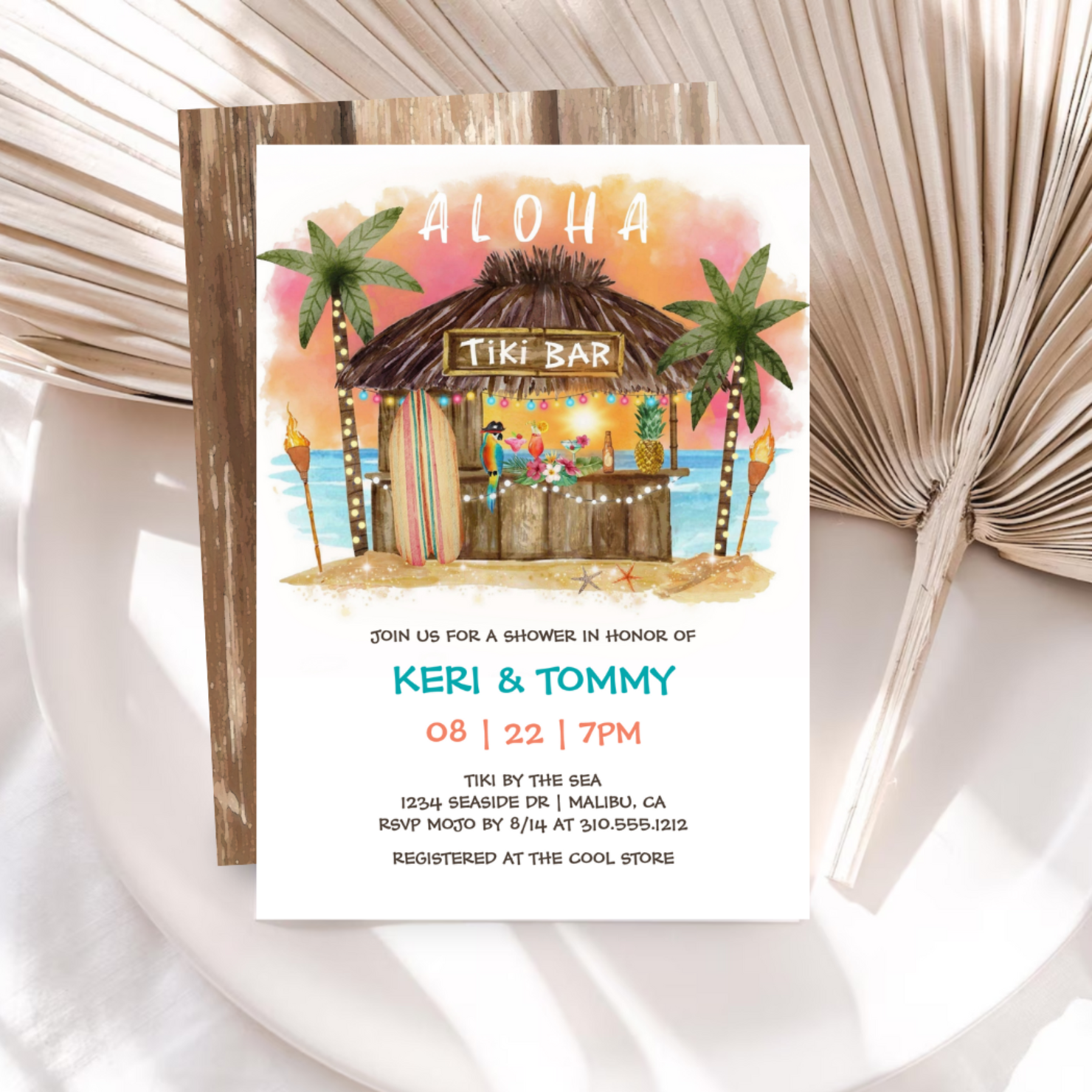 Island inspired bridal or couple's shower invitation featuring a tiki bar on a tropical beach with an Aloha greeting, cocktails, palm trees, surfboard and ocean backdrop.