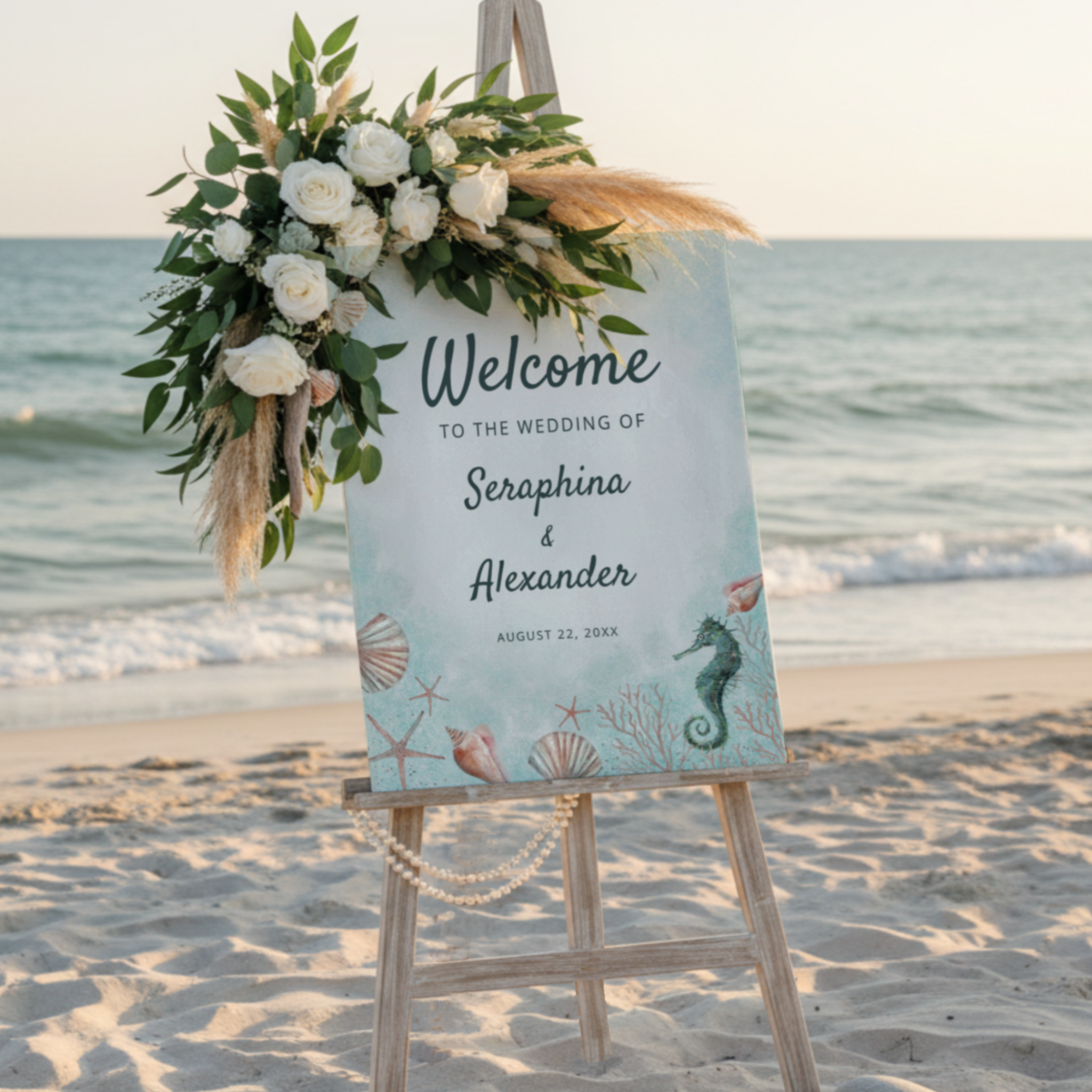 Coastal wedding welcome sign with watercolor seahorse, seashells, and coral on a blue ocean background.