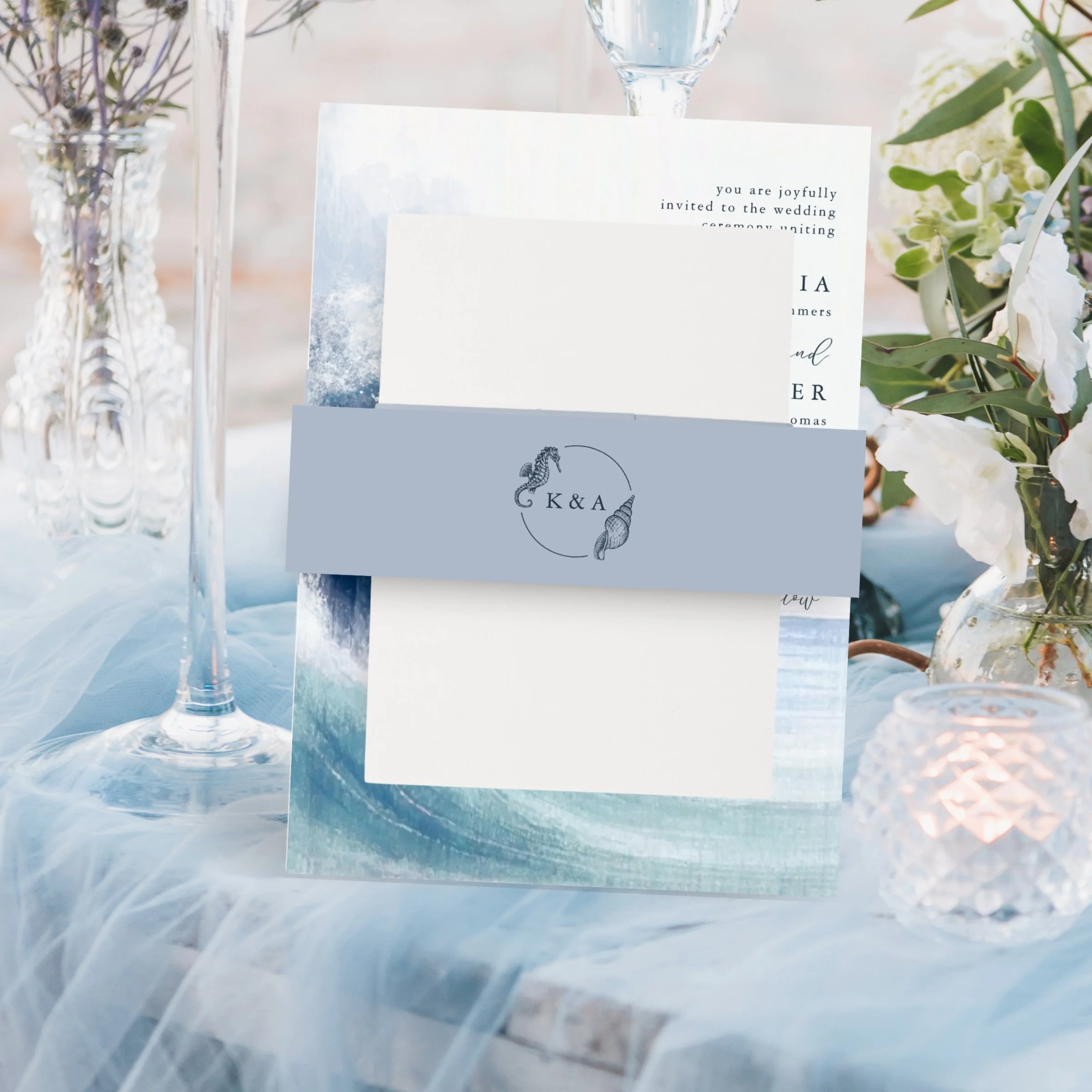 Finish your wedding invitation suite in nautical flair with these monogram belly bands in a stylish coastal blue color. The personalized monogram features a seahorse and sea shell ring with the couple’s initials in the center. Perfect for beach and s