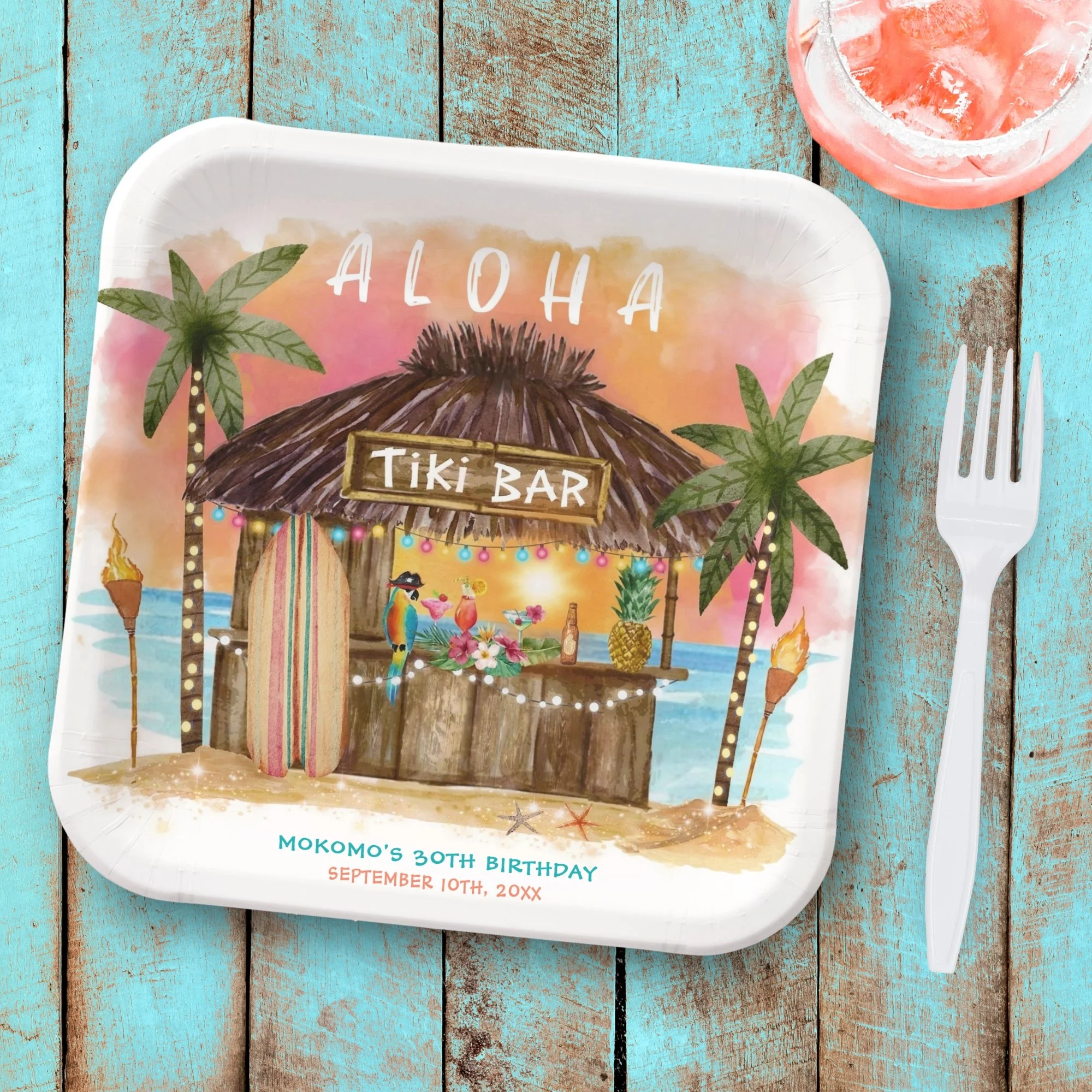 Tiki party birthday paper plates featuring a tiki bar on a tropical beach with ocean waves, cocktails and palm trees