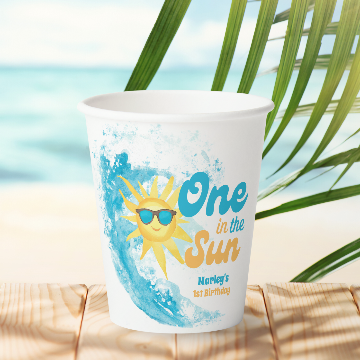 One in the Sun baby's 1st birthday paper cups featuring a cheeful sunshine, big ocean wave and turquoise and orange typography. Perfect for kid's summer first birthdays and coastal themes