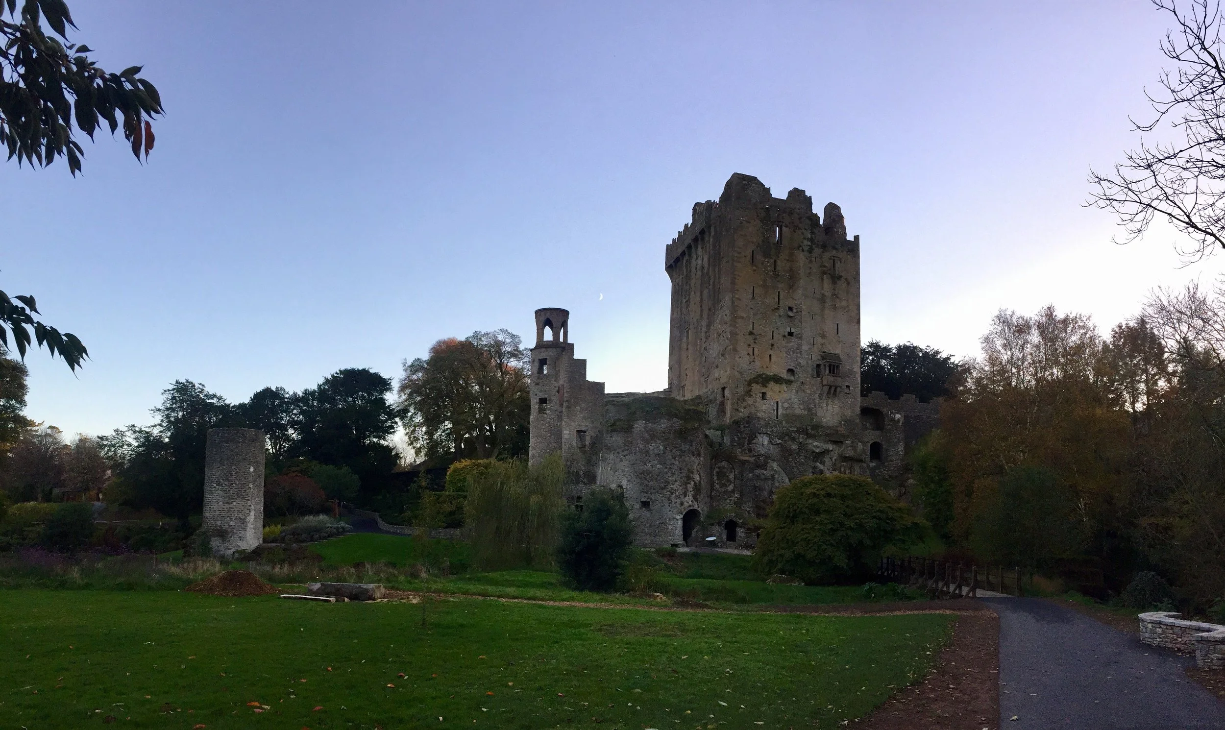 Gondola boat on a canal with people underneath a stone bridge in Venice, Italy.