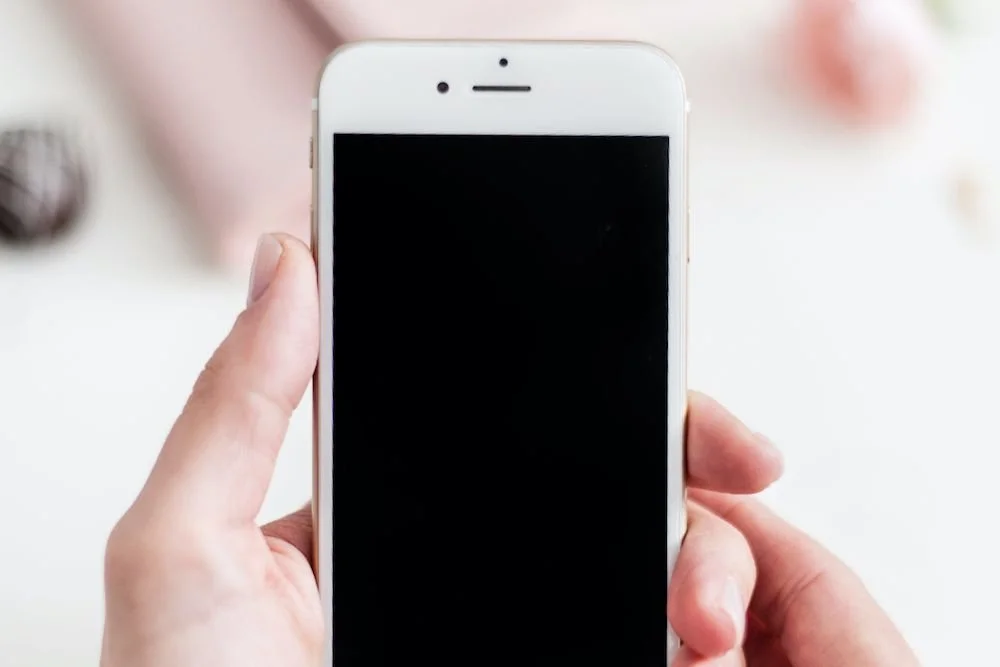 Hands holding a smartphone, a common tool for searching symptoms online when health anxiety builds.Boundary script graphic: Acknowledge, set the Boundary, then offer a Creative Yes when a parent criticizes your choices.