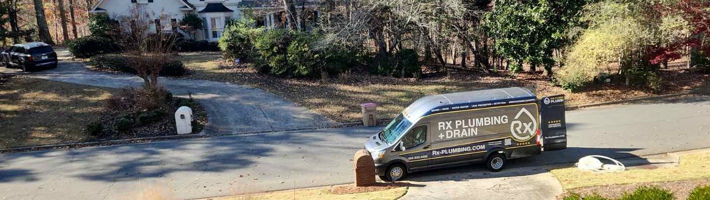 An Rx Plumbing van stands outside a Cumming, GA home to repair a leaking main line.