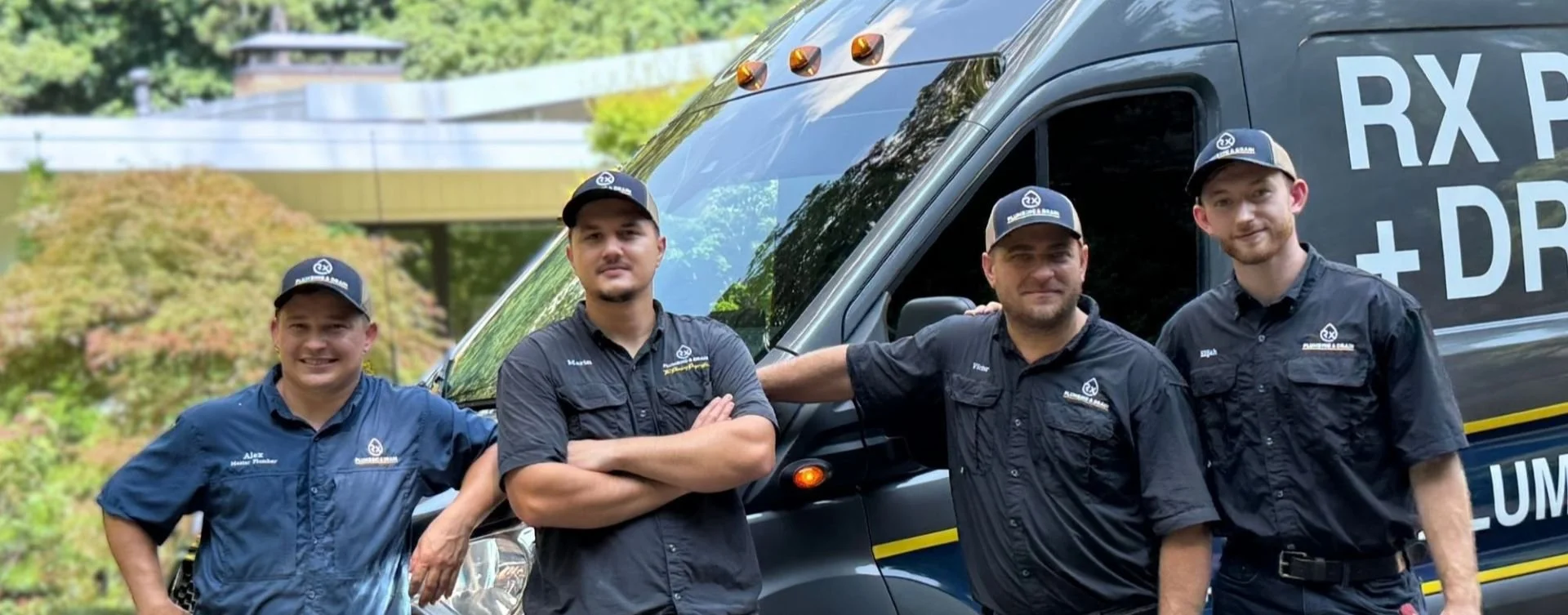 Rx-Plumbing and Drain team of professional plumbers in front of the Rx van.