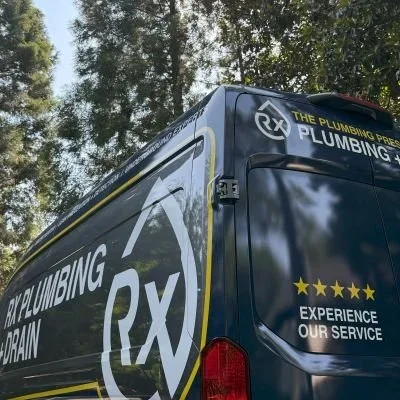 An Rx Plumbing emergency services van stands outside a Suwanee, GA home.
