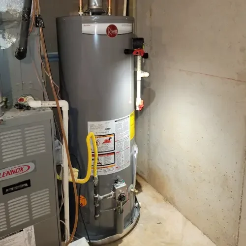 A newly installed Rheem traditional water heater stands inside a Cumming, GA basement.