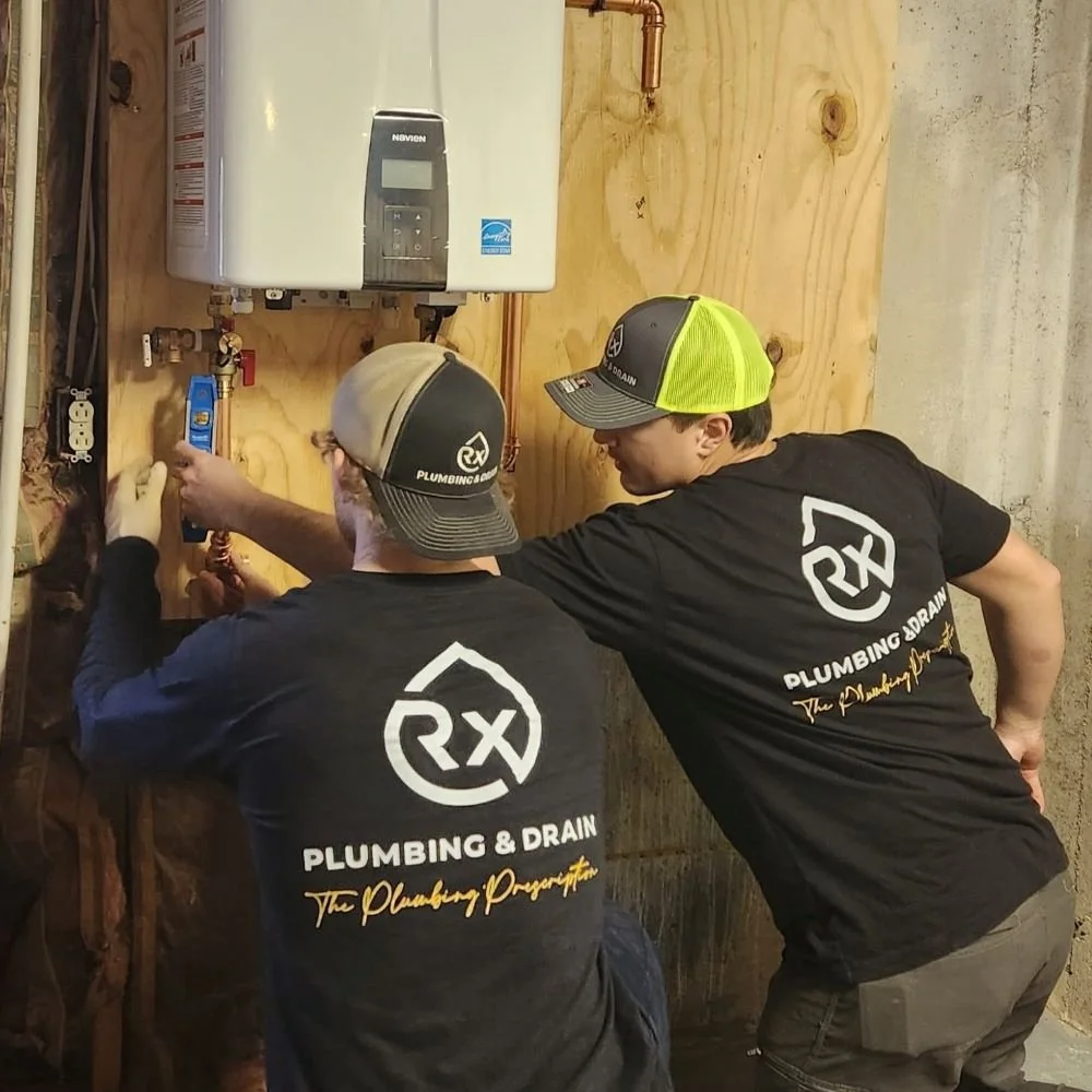 Rx-Plumbing and Drain plumbers installing a new Navien tankless water heater in a Cumming, Georgia home.