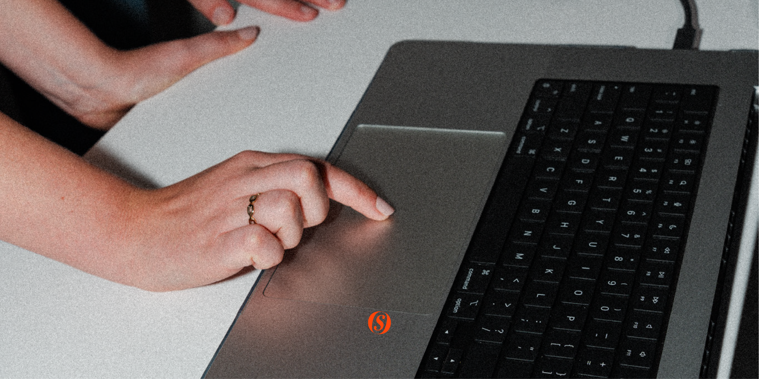 Finger on the trackpad of a Macbook Flash photography