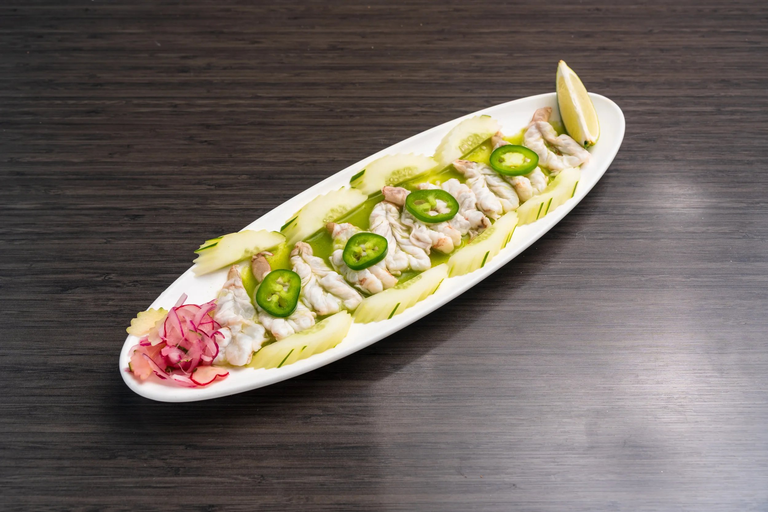Fresh aguachile prepared to order with seafood and citrus at El Muelle Seafood.