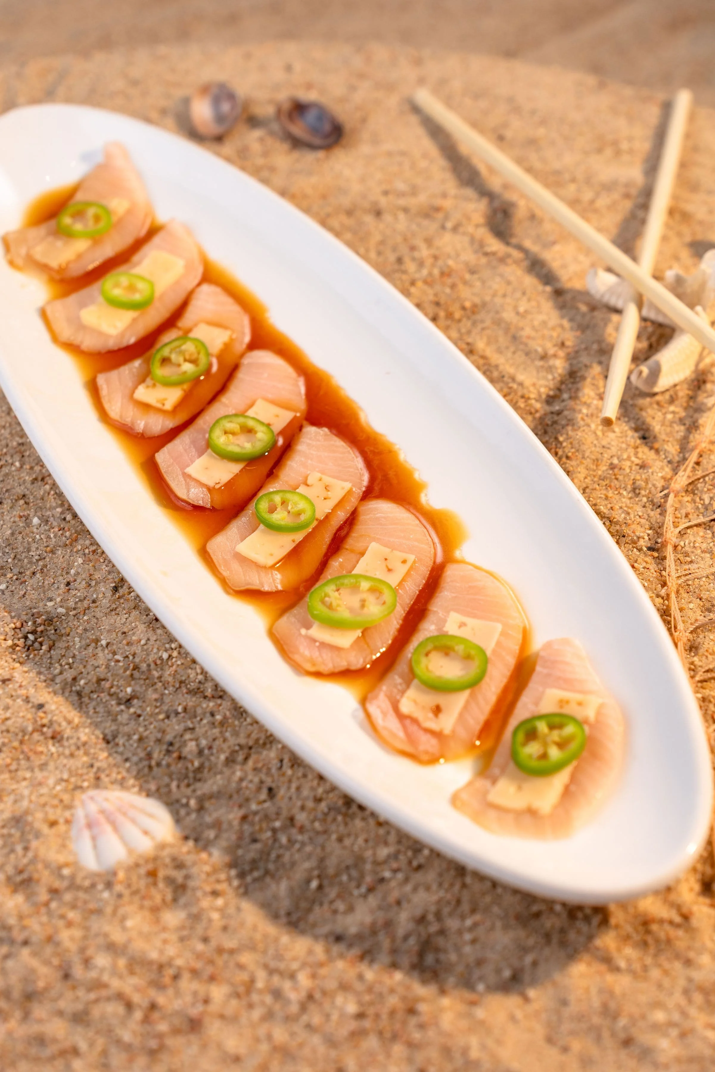 Hamachi tiradito with house sauce, Parmesan cheese and jalapeño at El Muelle Seafood in Houston