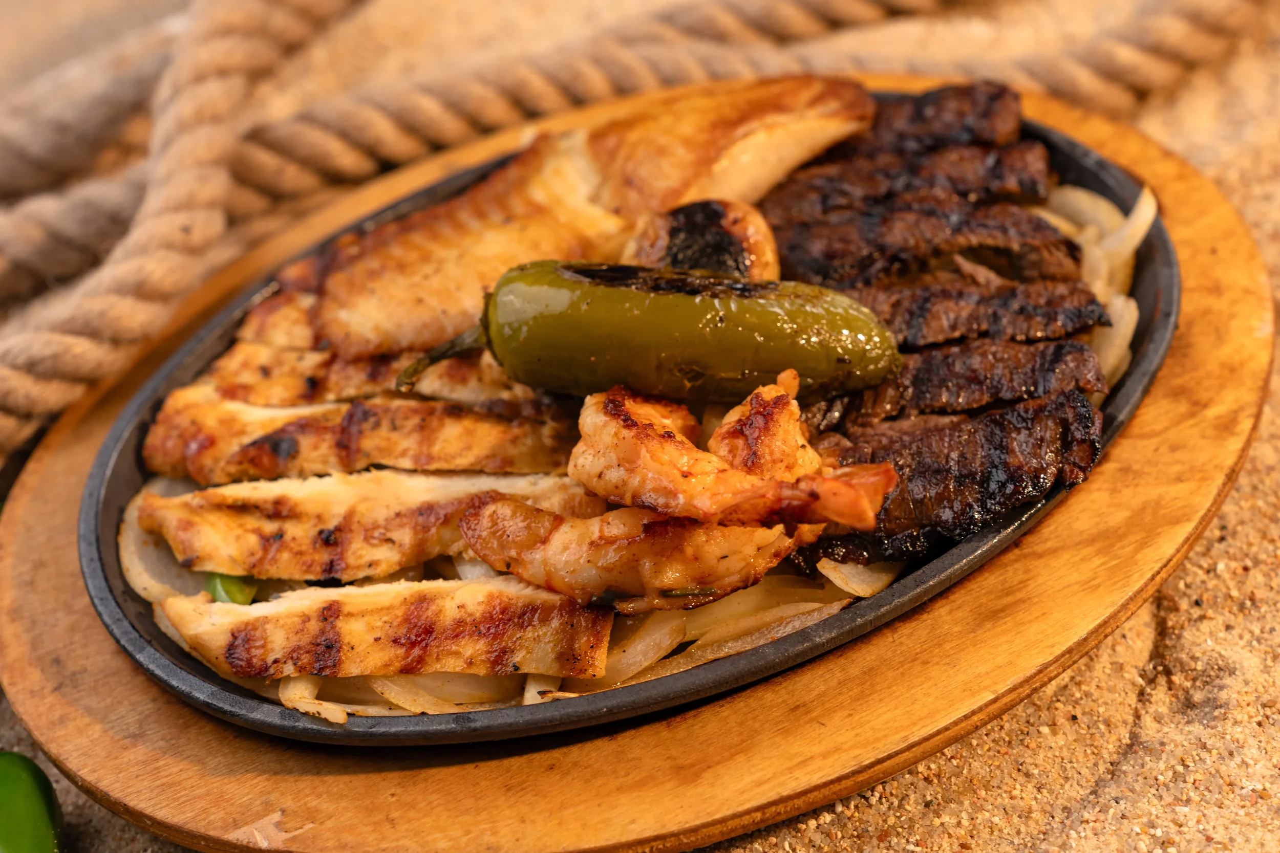 Mar y Tierra platter with grilled shrimp, fish, steak and chicken served at El Muelle Seafood restaurant in Houston.