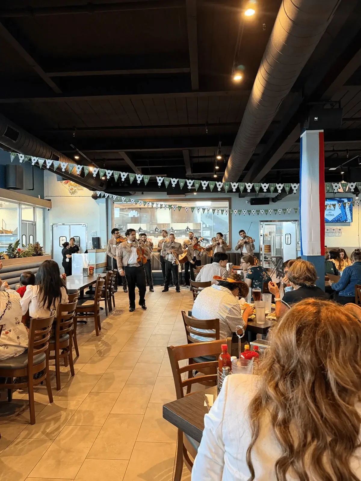 Live mariachi performance entertaining guests at El Muelle Seafood restaurant in Houston.