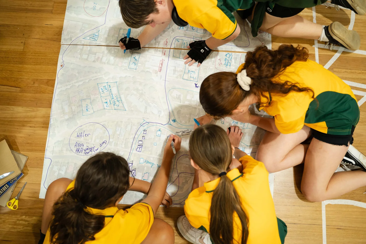 Community members co-designing around a large map
