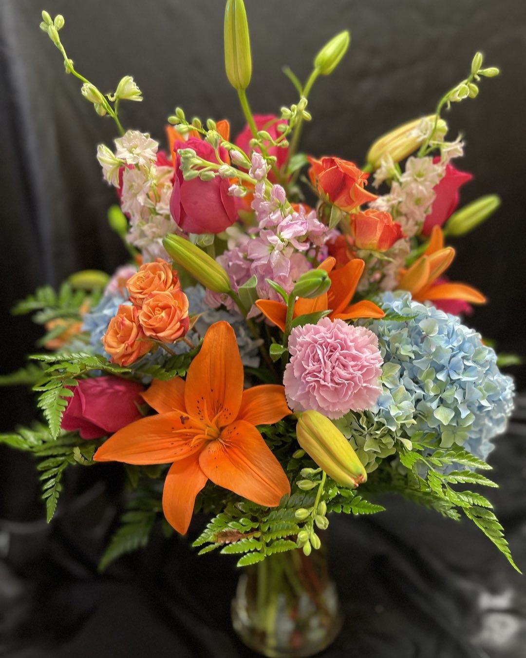 Bouquet of bright flowers including rose blooms