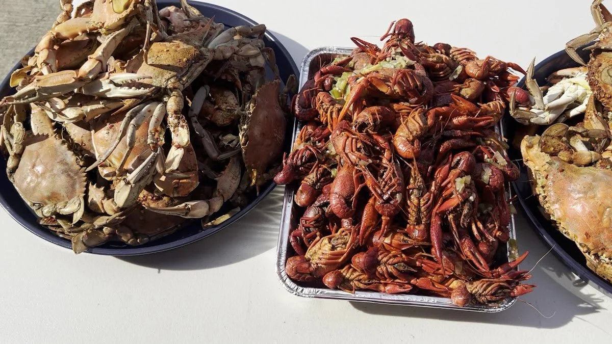 Plate of crabs next to tray of crawfish