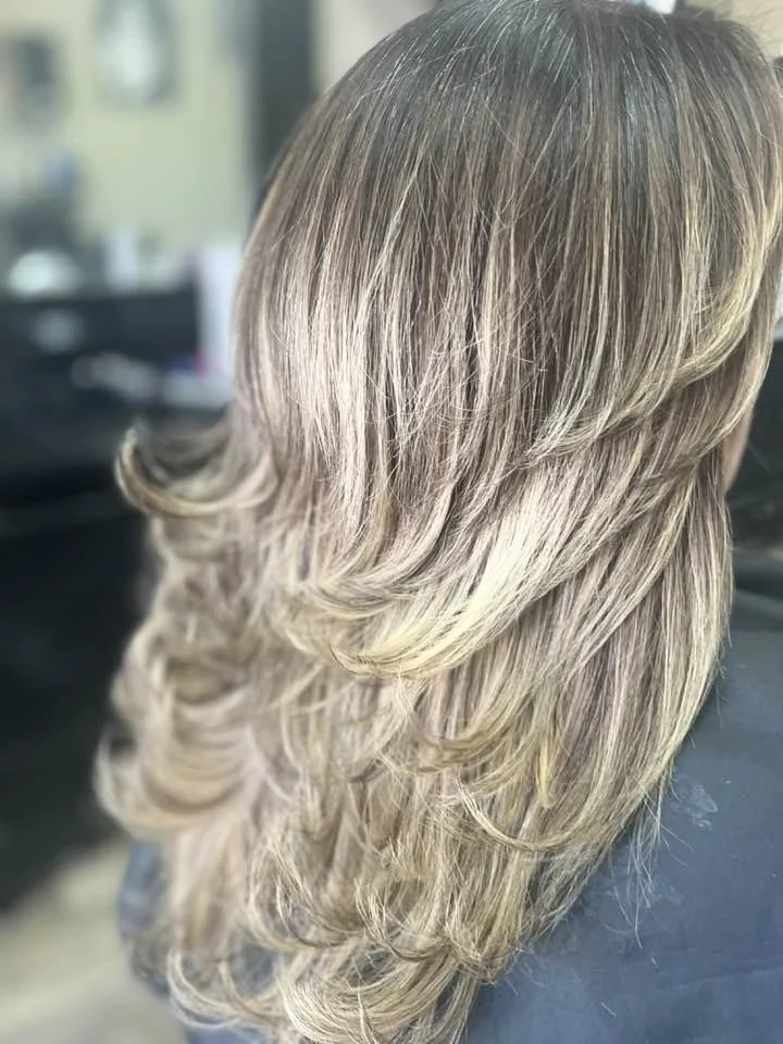 Blonde woman showing back of head after getting hair styled