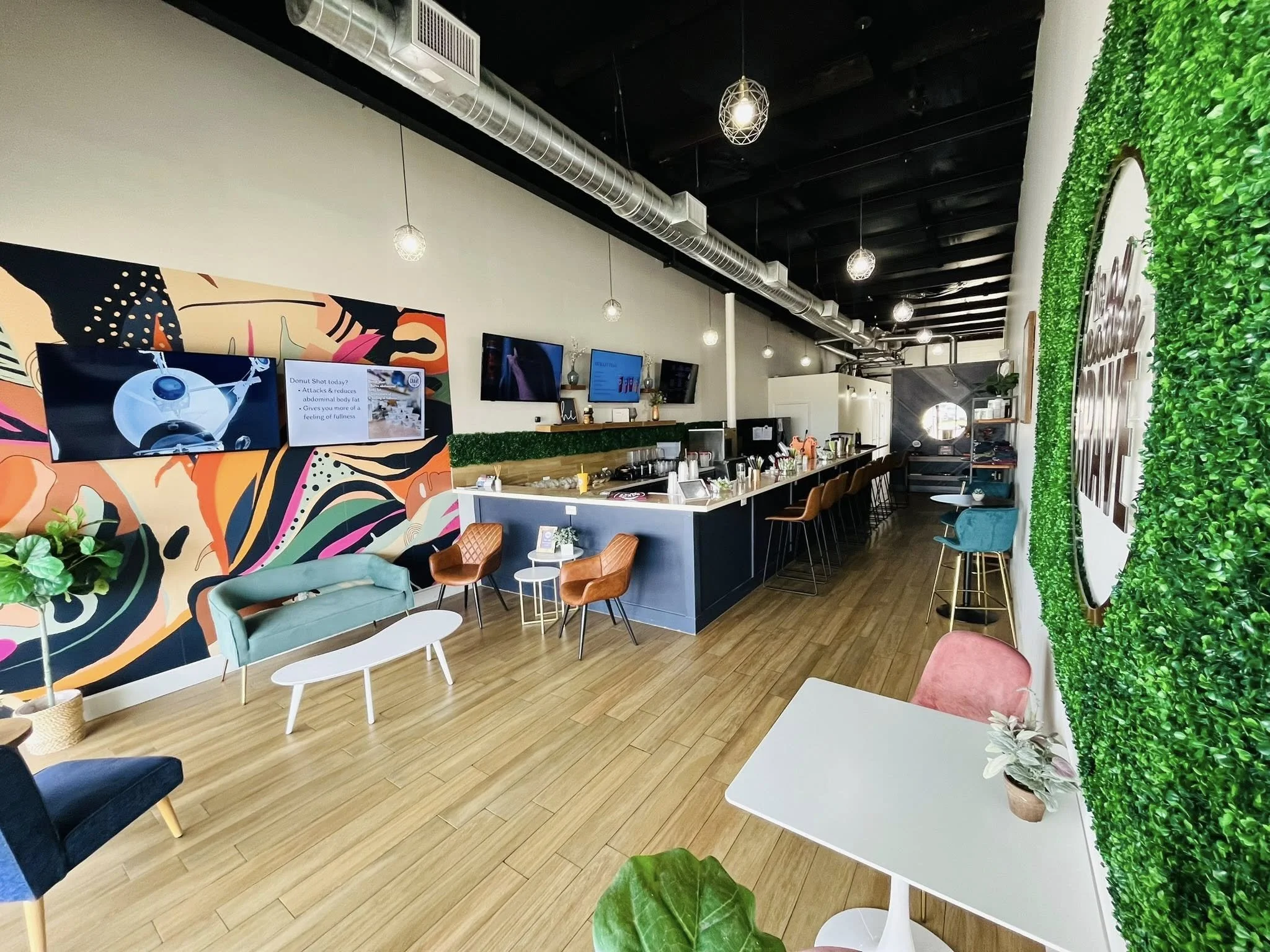 Cafe with colorful wall art and decor and an Industrial celing