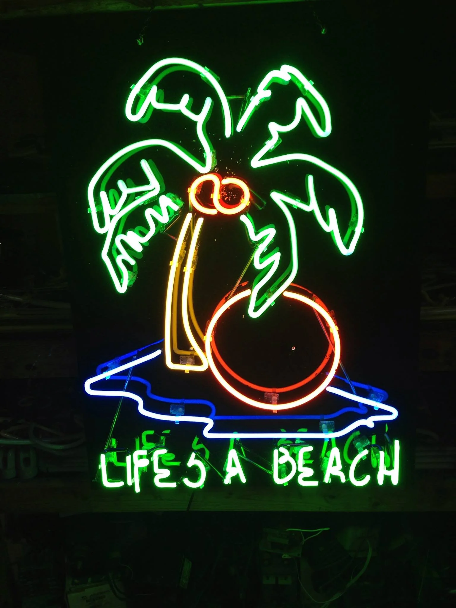 Neon sign of palm tree with coconuts