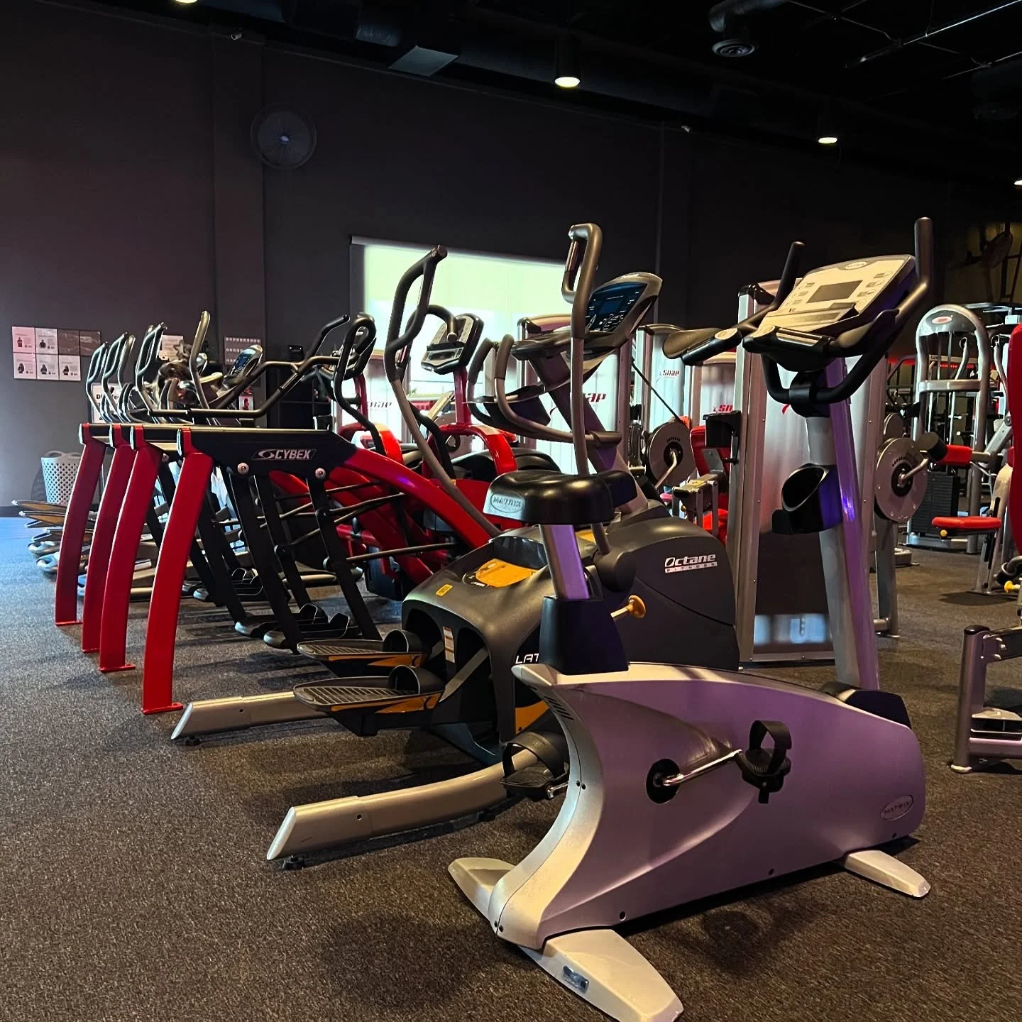 Inside of gym with treadmills and stationary bike