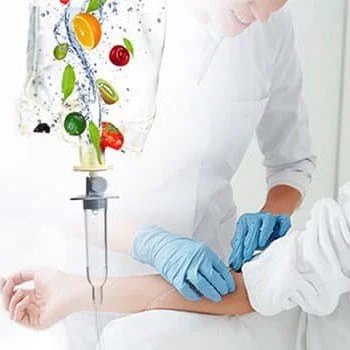 Nurse inserting IV into patient with healthy fruits streaming into IV bag