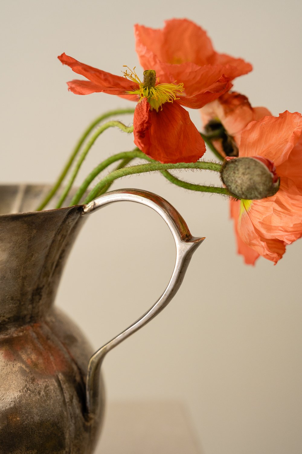Embark the Studio Thomas client experience orange flowers in silver KTHOM pitcher
