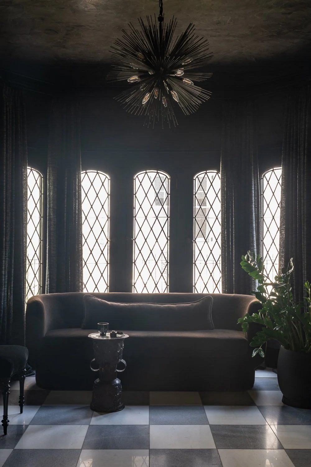 Studio Thomas timeless bespoke interior architecture no 026 whiskey room black color drenched plaster walls curved brown sofa