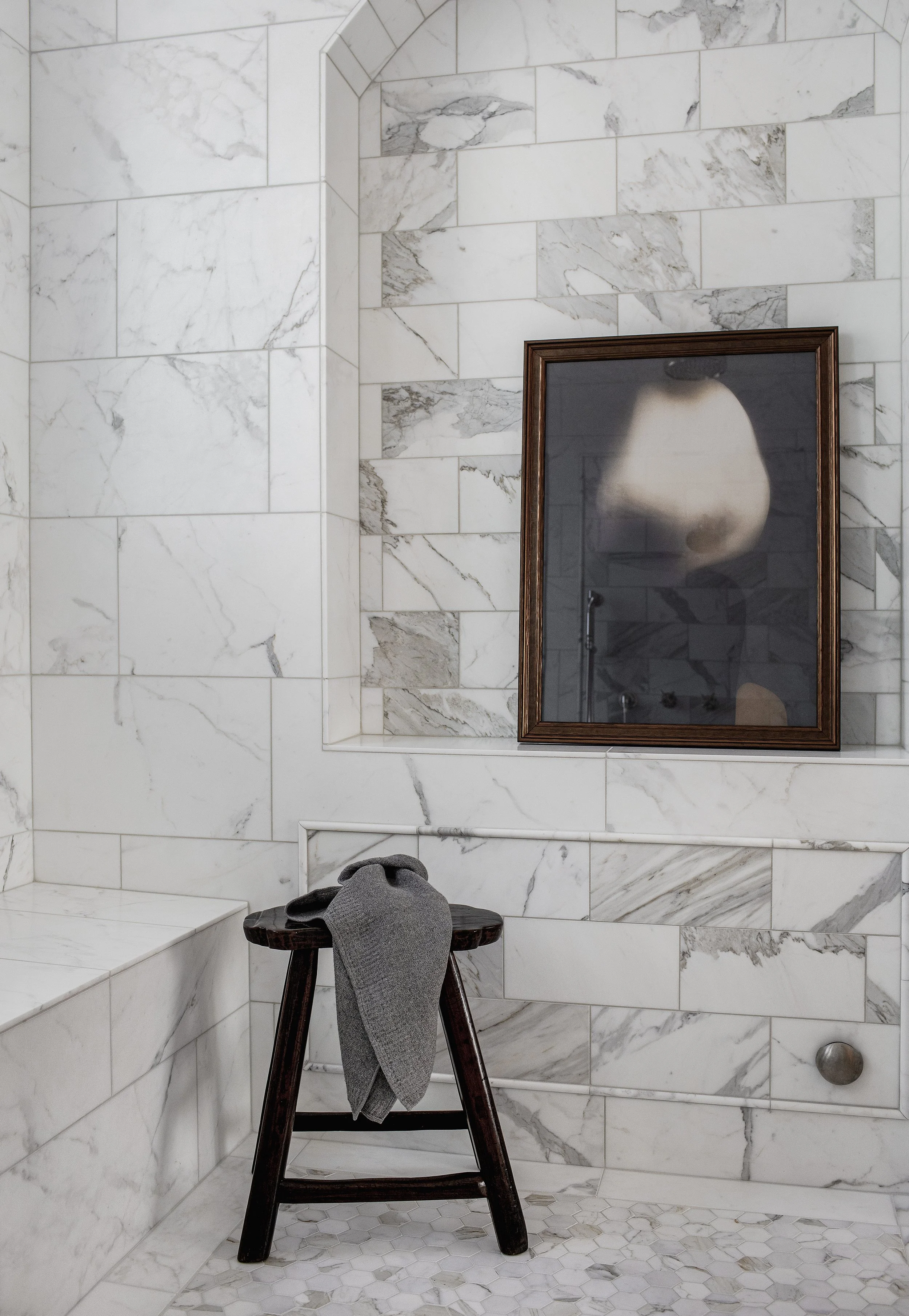 Studio Thomas no 011 master bathroom shower marble tile antique wooden stool artwork