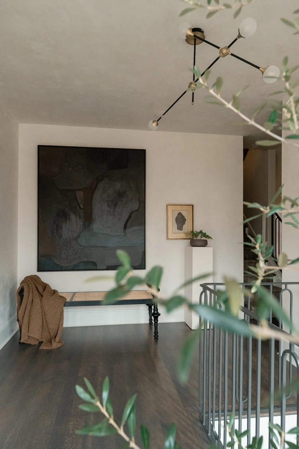 Studio Thomas timeless bespoke interior architecture no 026 second floor landing custom artwork antique accessories dark hardwood flooring