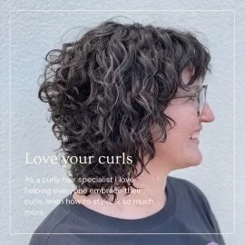 Person with curly hair, smiling and facing sideways, promoting curly hair care with text "Love your curls" overlaid.