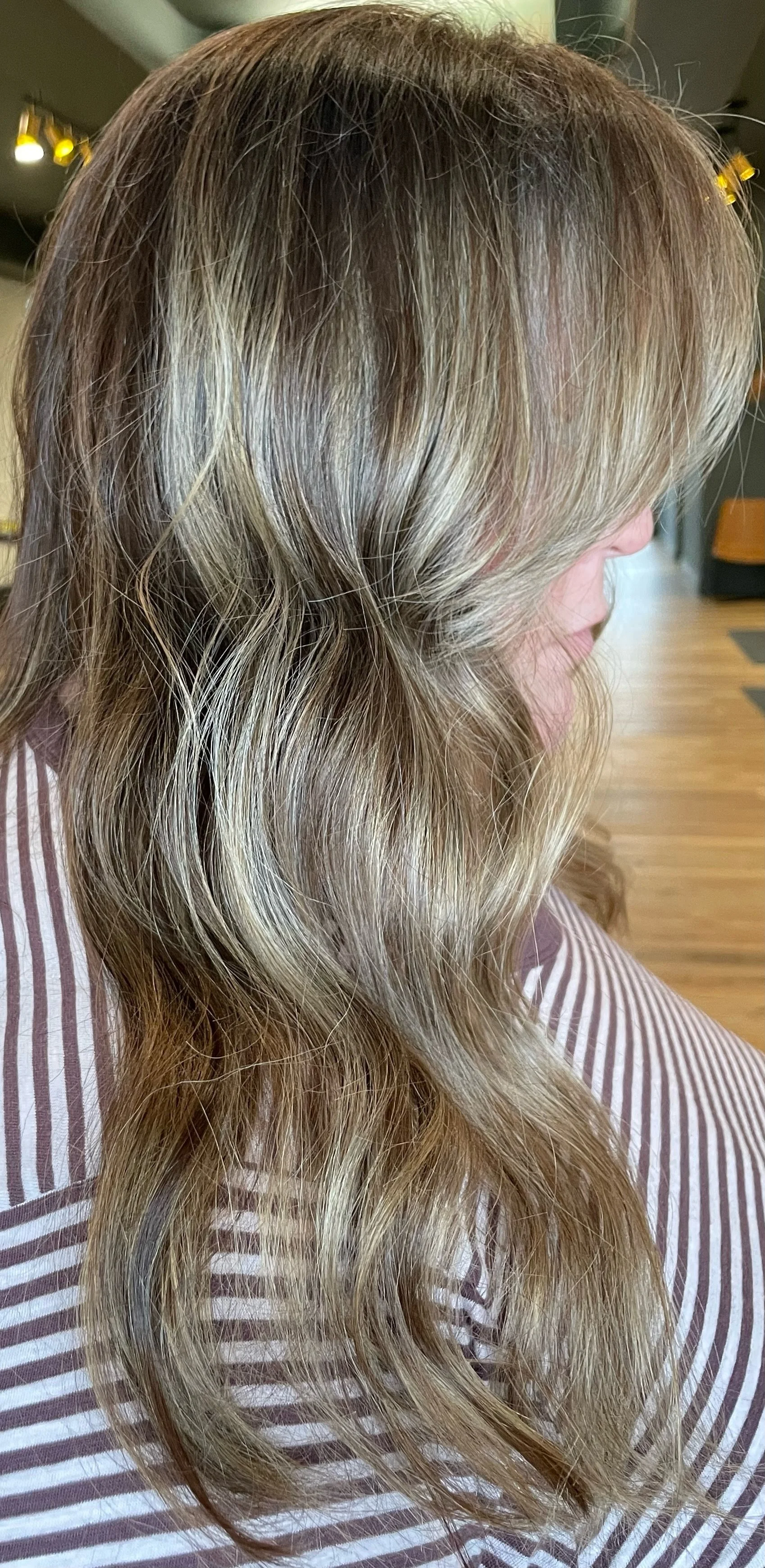 Side view of wavy blonde hair with highlights
