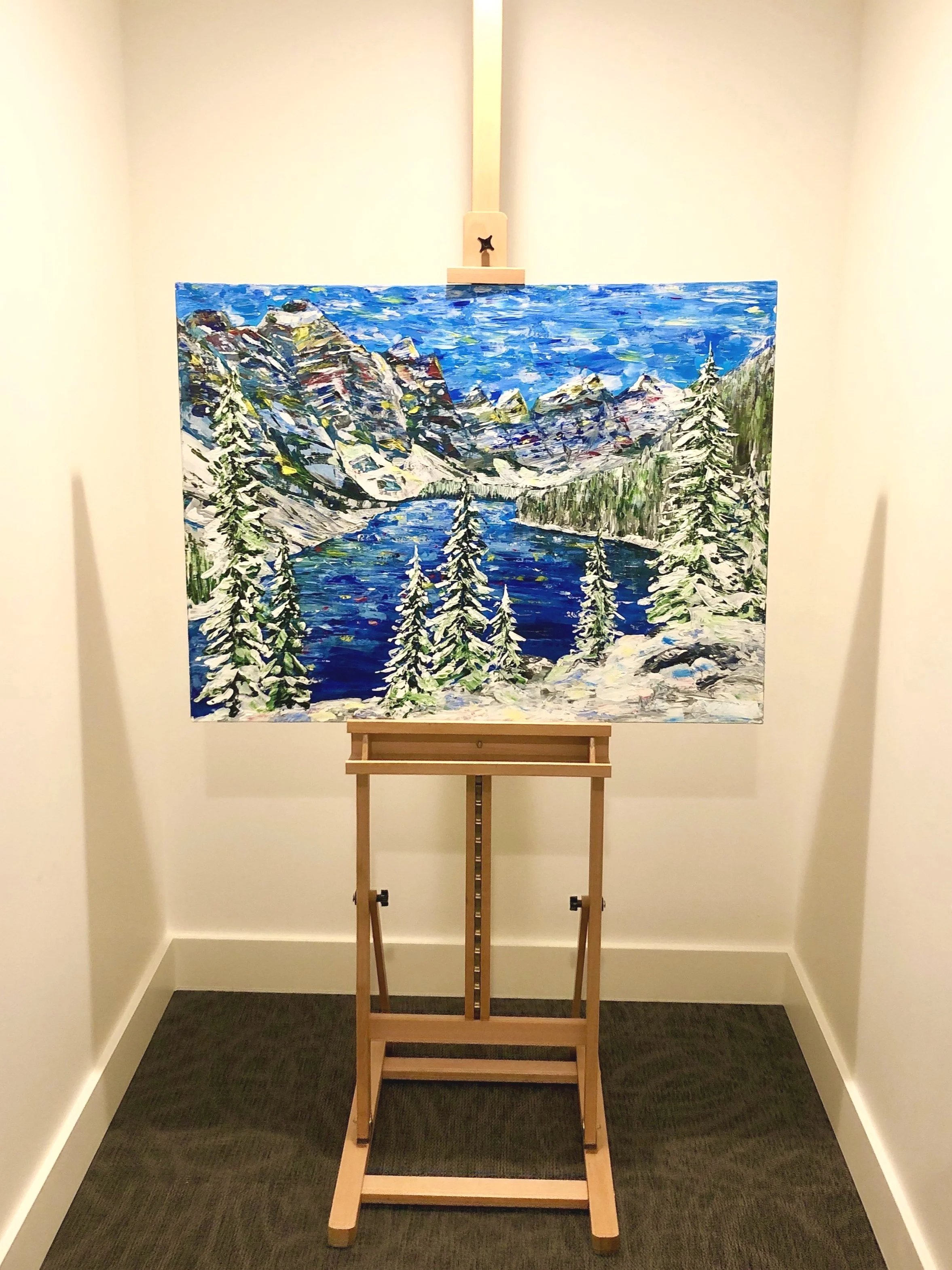 Alex Lorieau painting of Banff Ten Peaks Morraine Lake winter landscape, sitting on a wooden easel..