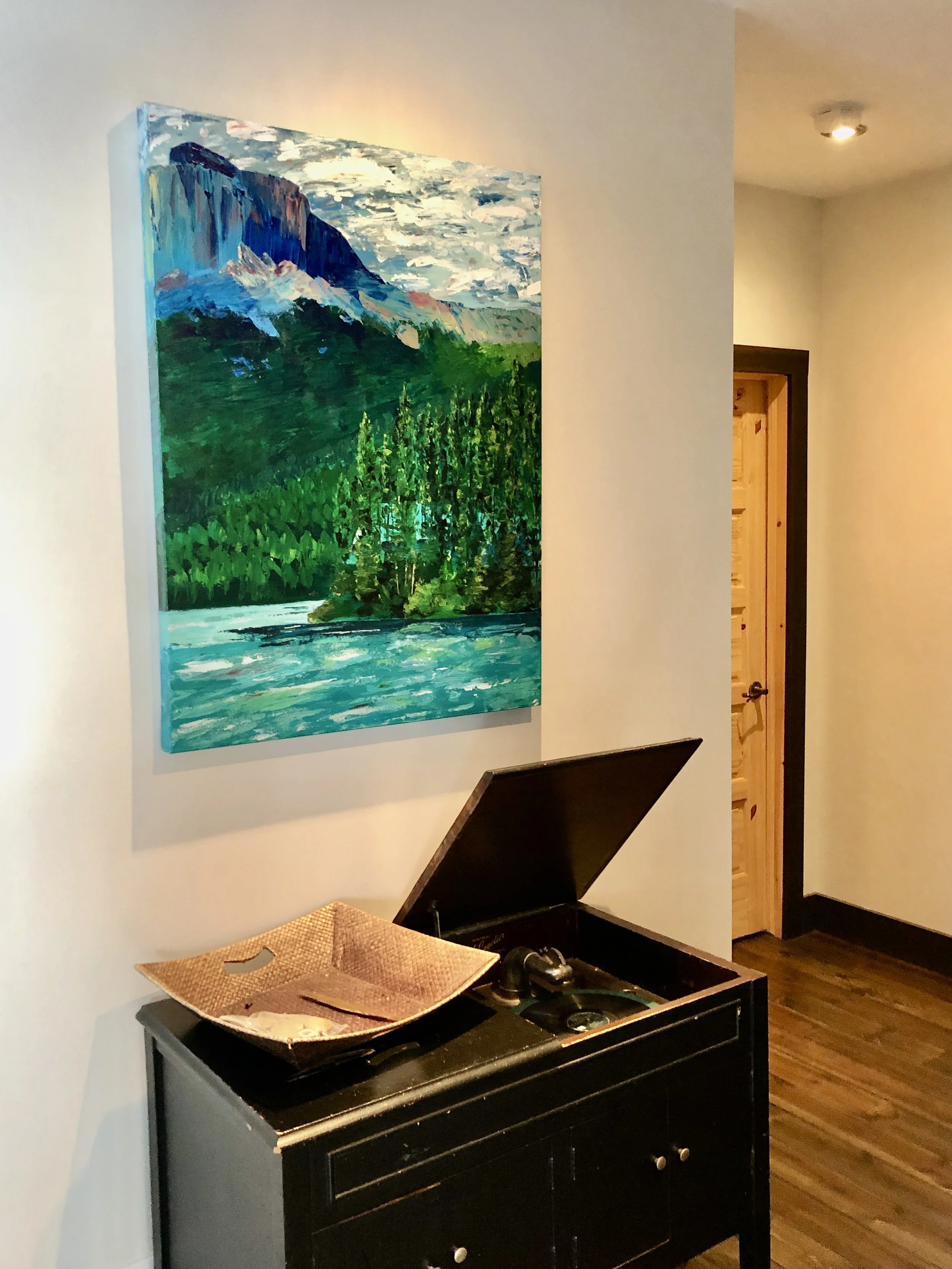 Emerald Lake Painting by Alex Lorieau hung on wall in home.