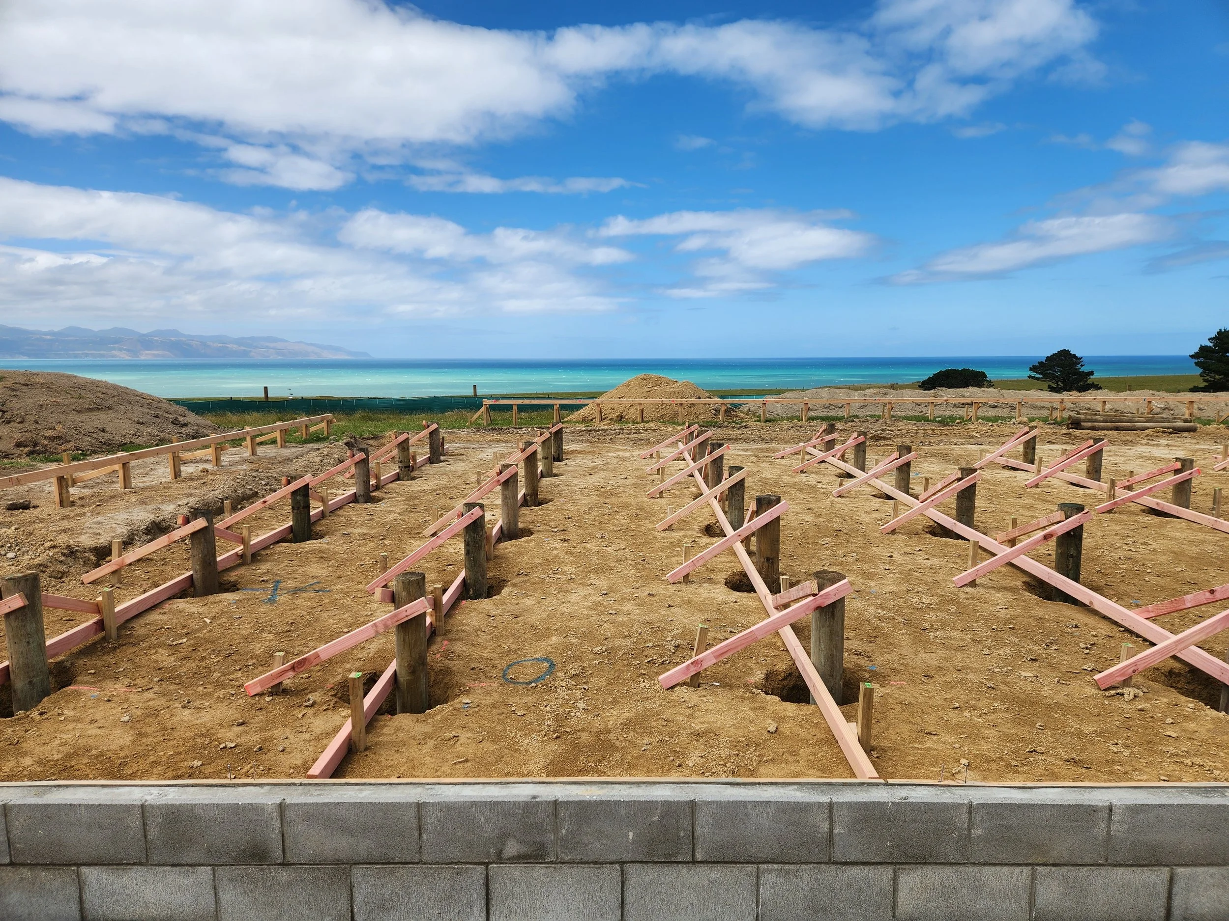 a block wall and timber house piles for a residential house foundation